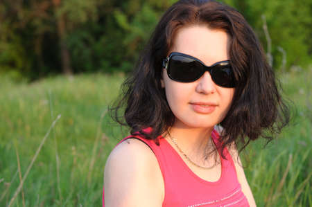 Young, beautiful girl on a green meadowの写真素材