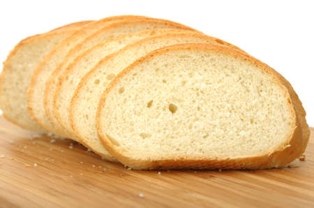 The cut bread on a chopping board. It is isolated on a white backgroundの写真素材