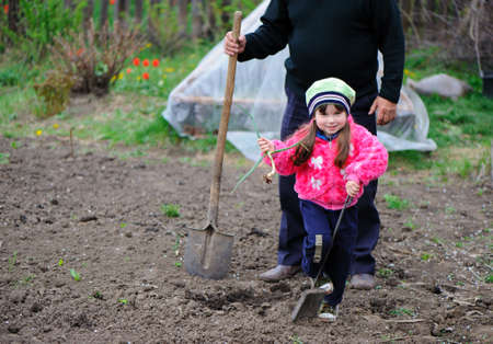 The little girl works in the garden. Autumnの写真素材