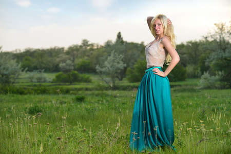 Portrait of pretty girl standing in the field. Shooting outdoorsの写真素材