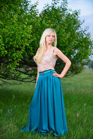 Portrait of pretty girl standing in the field. Shooting outdoorsの写真素材