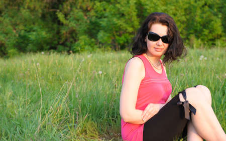 Young, beautiful girl on a green meadowの写真素材