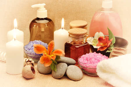 Object for the spa. Candles burning, pebble, a Lily, a bottle with oil, liquid soap, and more.の写真素材