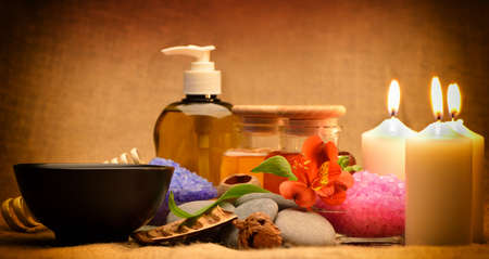 Object for the spa. Candles burning, Pebble, Lily, liquid soap, a bottle with oil, bowl with the petals of roses in water, and another.の写真素材