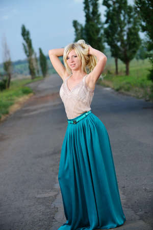 Portrait of a pretty woman standing on the road. Shooting outdoorsの写真素材