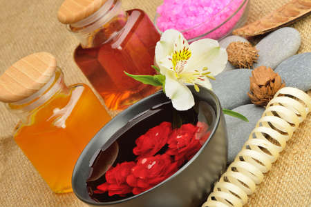 Object for the spa. Candles burning, Pebble, a Lily, a bottle with oil, bowl with the petals of roses in water, and another.の写真素材