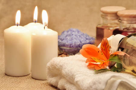 Object for the spa. Candles burning, pebble, a Lily, a bottle with oil, liquid soap, and more.の写真素材