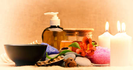 Object for the spa. Candles burning, Pebble, Lily, liquid soap, a bottle with oil, bowl with the petals of roses in water, and another.の写真素材