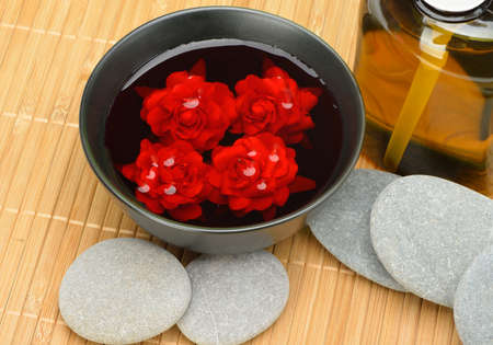 Object for the spa. Pebble, Lily, liquid soap, bowl with roses in water.の写真素材