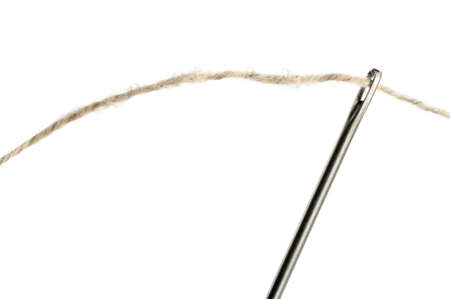 Needle and thread closeup. Isolated on white backgroundの写真素材