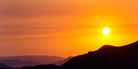 Colourful decline over mountains. Red colourの写真素材