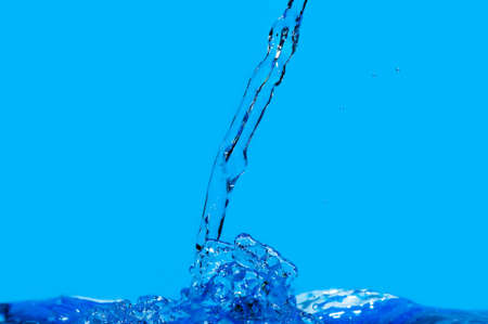 Splashes and water waves. Blue backgroundの写真素材