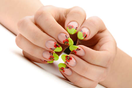 Female hands with manicure closeup. Isolated on white. Drawing red poppy flowers.の写真素材