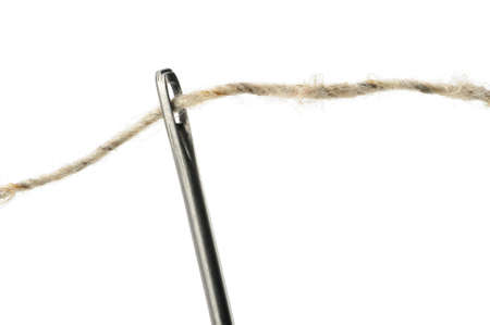 Needle and thread closeup. Isolated on white backgroundの写真素材