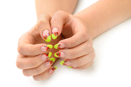 Female hands with manicure closeup. Isolated on white. Drawing red poppy flowers.の写真素材