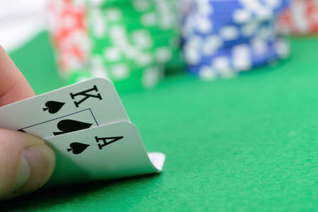 Gaming cards  in hand on the green cloth. A winning combination in Black Jack