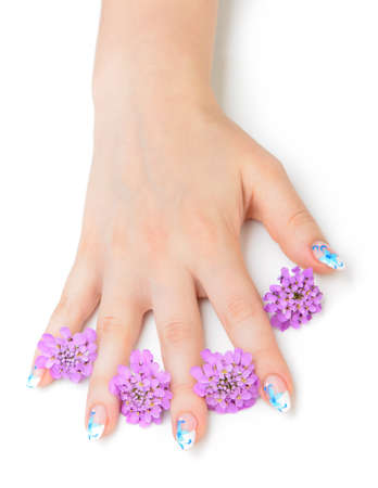 Nail art. Female nails with figure of petal blue color closeup and flowerの写真素材
