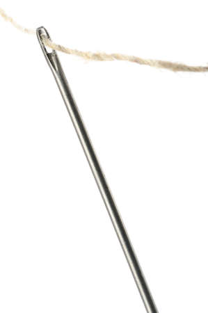 Needle and thread closeup. Isolated on white background