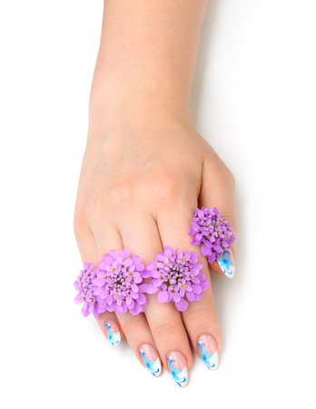 Nail art. Female nails with figure of petal blue color closeup and flowerの写真素材