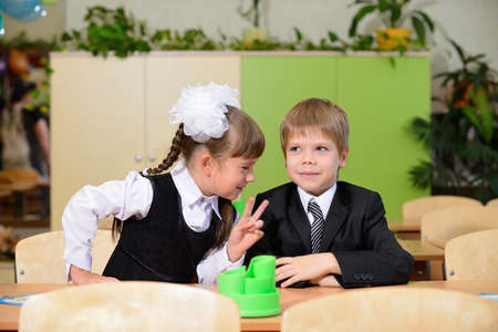 The conversation schoolchild. Sitting at a Deskの写真素材