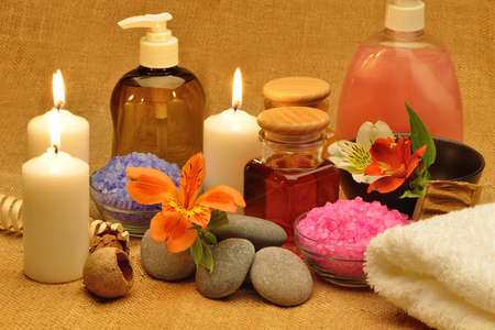 Object for the spa. Candles burning, pebble, a Lily, a bottle with oil, liquid soap, and more.の写真素材