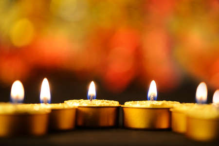 Golden burning candles bokeh blured backgroundの写真素材