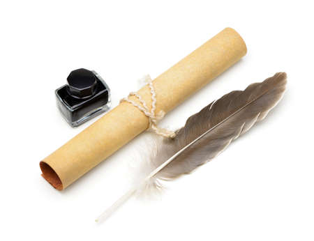 A feather pen, ink,rolls of old yellowed paper. Isolated on a white background.の写真素材