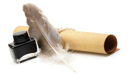 A feather pen, ink,rolls of old yellowed paper. Isolated on a white background.の写真素材