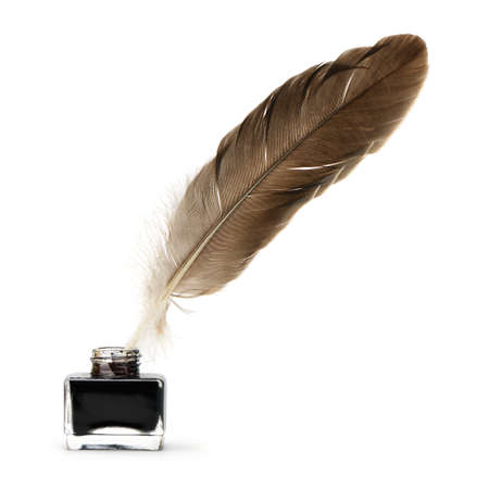 Feather pen into the inkwell. Isolated on a white background.の写真素材