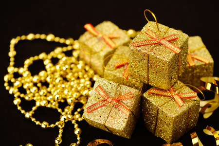 Gold box with gifts. On black backgroundの写真素材
