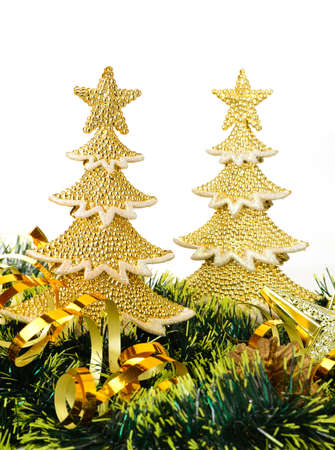 gold decorated Christmas trees and holiday object. Isolated on whiteの写真素材