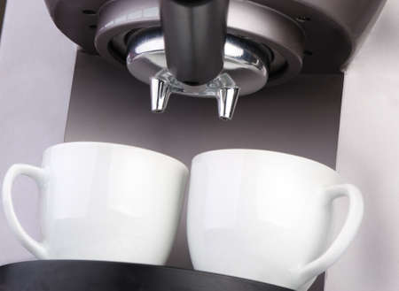Coffee machine espresso. Two white cups and the equipment for coffee preparation. A close upの写真素材