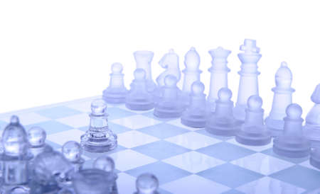 Glass chess. The first move. Blue toned.の写真素材