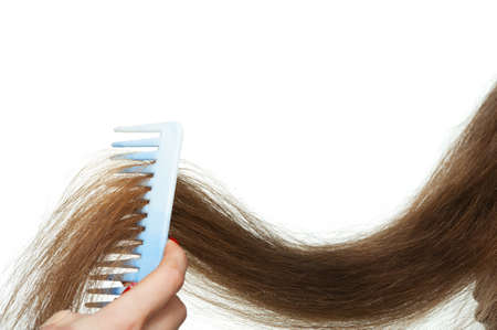 Hairbrush and long hair. It is isolated on a white backgroundの写真素材