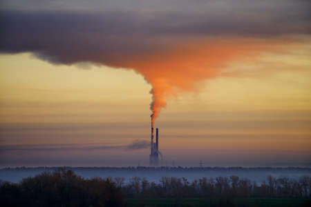 The red smoke from industrial pipes. The concept of environmental pollutionの写真素材