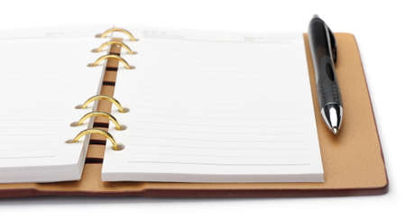 Open notebook with copper binding and stylish pen. It is isolated on a white backgroundの写真素材