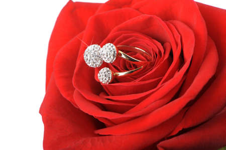 Red rose with a ring with jewels. Isolated on whiteの写真素材