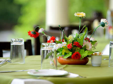 Table a summer cafe . Selectife focus. Dining accessories and flowersの写真素材