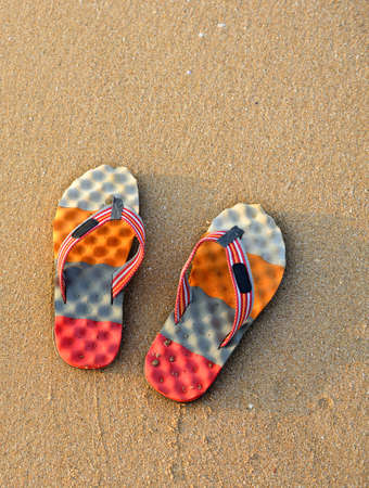 Colorful flip-flops on the sand. The shore of the Indian oceanの写真素材