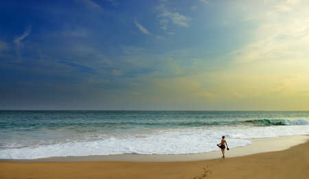 woman on the wide beach of the ocean. Beautiful shores of the Indian oceanの写真素材
