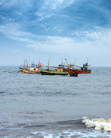 Fishing boats in the ocean . The brightly colored boats moored to the shore of the Indian oceanの写真素材