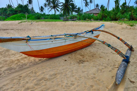 Fishing boats on a tropical beach . The brightly colored boats for fishingの写真素材