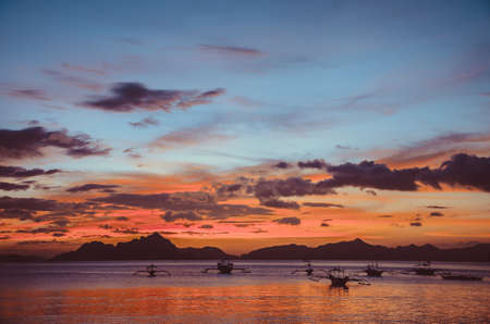Red Sunset in El Nido, bancas in sea, Palawan, Philippines, vintage lookの写真素材