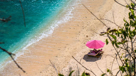 Lila Sunbed on Beautiful White Sand. Clear Blue Ocean, Atuh Beach, Nusa Penida, Bali, Indonesia.の写真素材