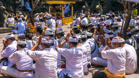 Unidentified Indonesian people go to celebrate Balinese ceremony at Pura Goa Lawah temple, Bali, Indonesia.のeditorial素材