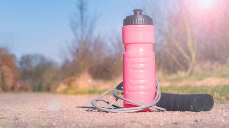 Skipping rope and water bottle on the ground outoorの写真素材