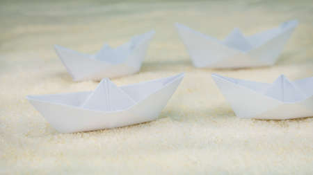 Blurred Paper Ships on Sandy Surface simulated Desertの写真素材