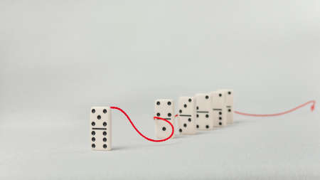 Leadership concept. One domino figure represent major person lead further items in red towの写真素材
