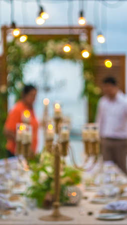 Blurred of Table in the Restaurant witch candles and servant on the Beach, Baliの写真素材
