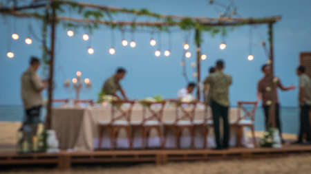 Blurred of Table in the Restaurant witch candles and servants on the Beach, Baliの写真素材